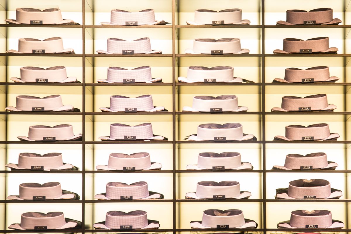 Organized collection of neatly stacked dress shirts showcased on shelves in a stylish fashion store.