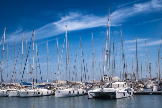 Sailboats and yachts moored at a scenic marina in Foça, İzmir on a sunny day.