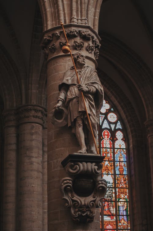 Man Holding Rod Statue