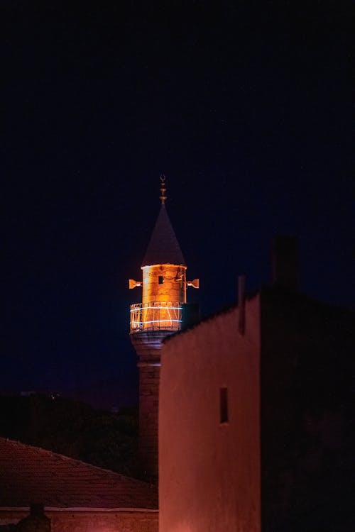 A tower with a clock on top at night