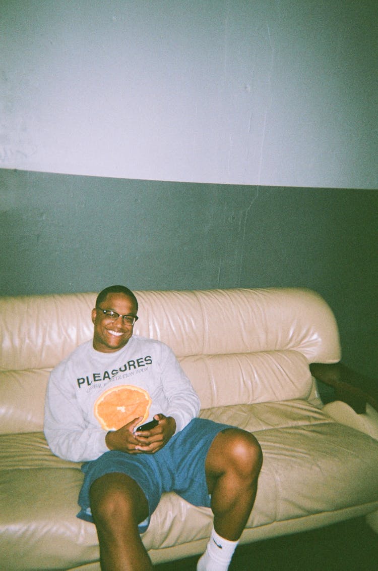 Photo Of Man Sitting On Leather Sofa