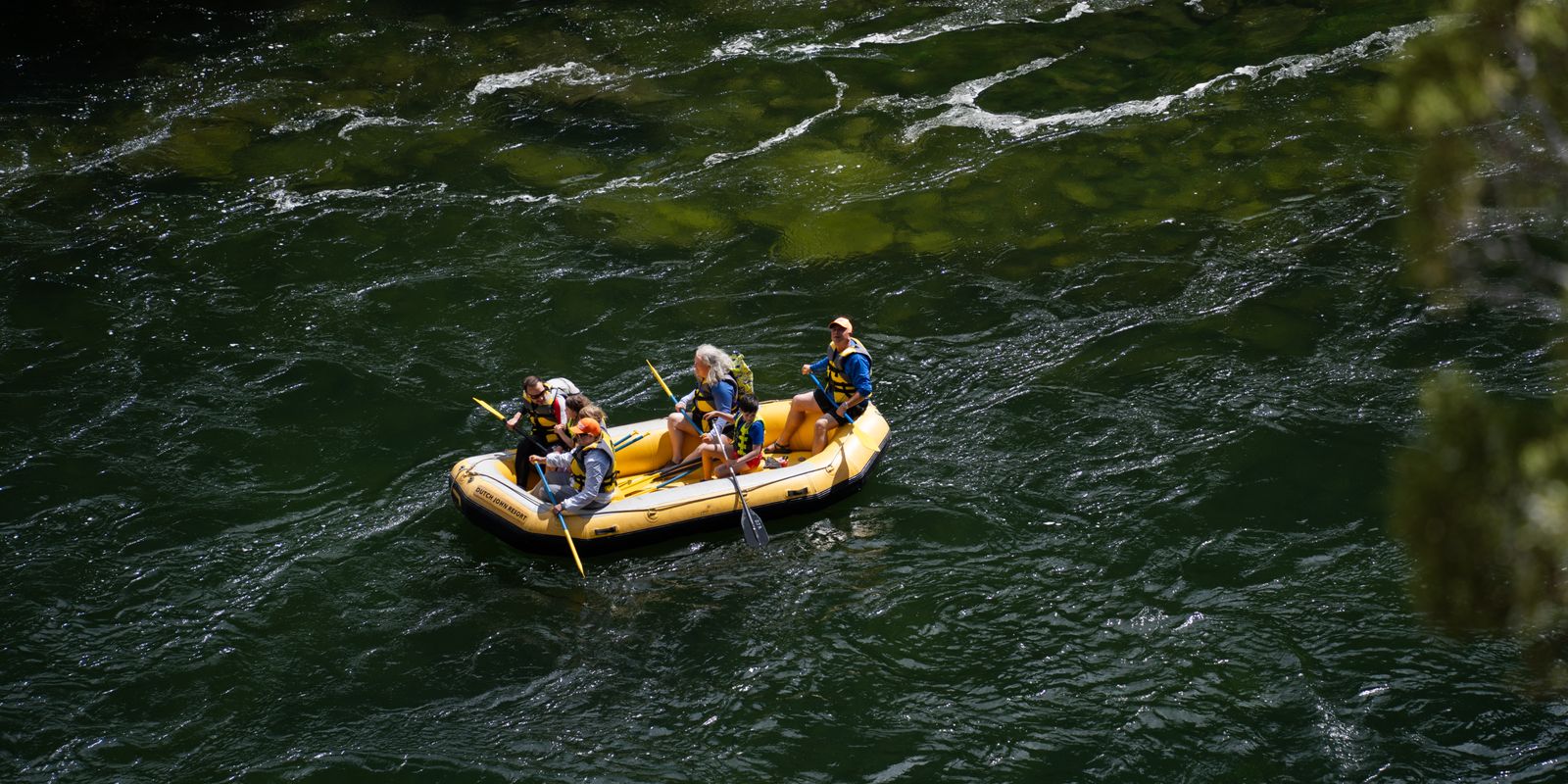A family enjoying a gentle rafting trip on a calm river