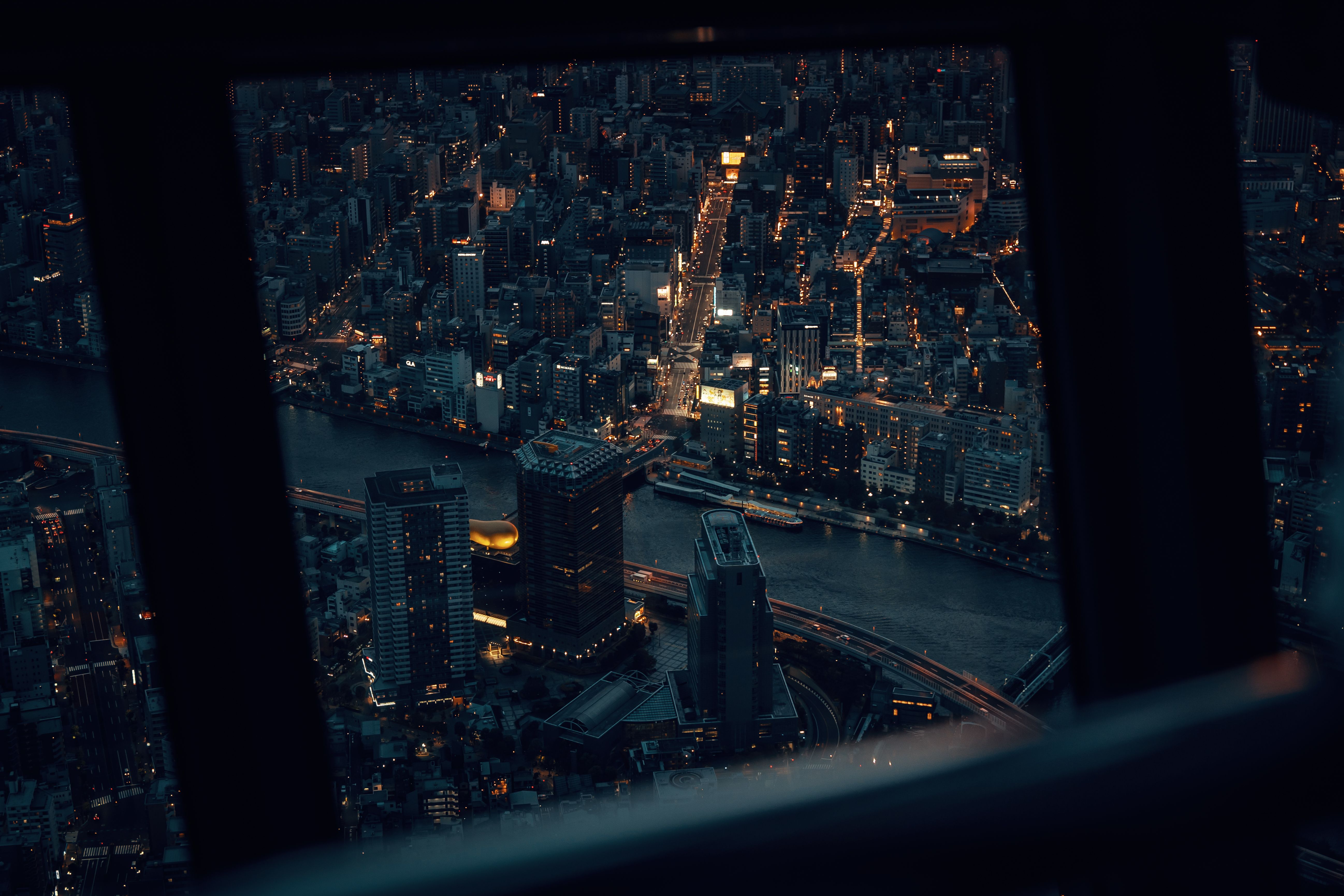 Captivating aerial view of Tokyo's illuminated cityscape at night, showcasing urban density and architectural beauty.
