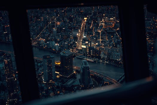 Captivating aerial view of Tokyo's illuminated cityscape at night, showcasing urban density and architectural beauty.
