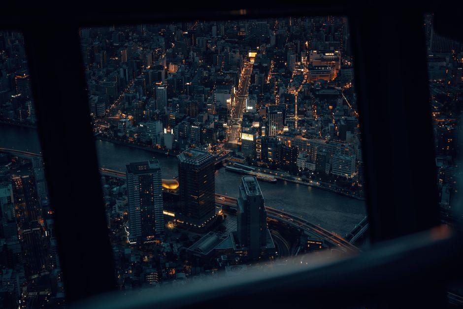 Captivating aerial view of Tokyo's illuminated cityscape at night, showcasing urban density and architectural beauty.