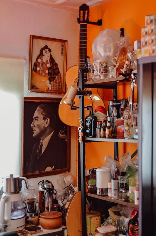 A kitchen with a guitar and a painting on the wall