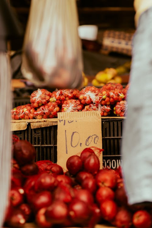 A fruit stand with apples and oranges on display