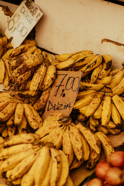 A bunch of bananas for sale with a price tag