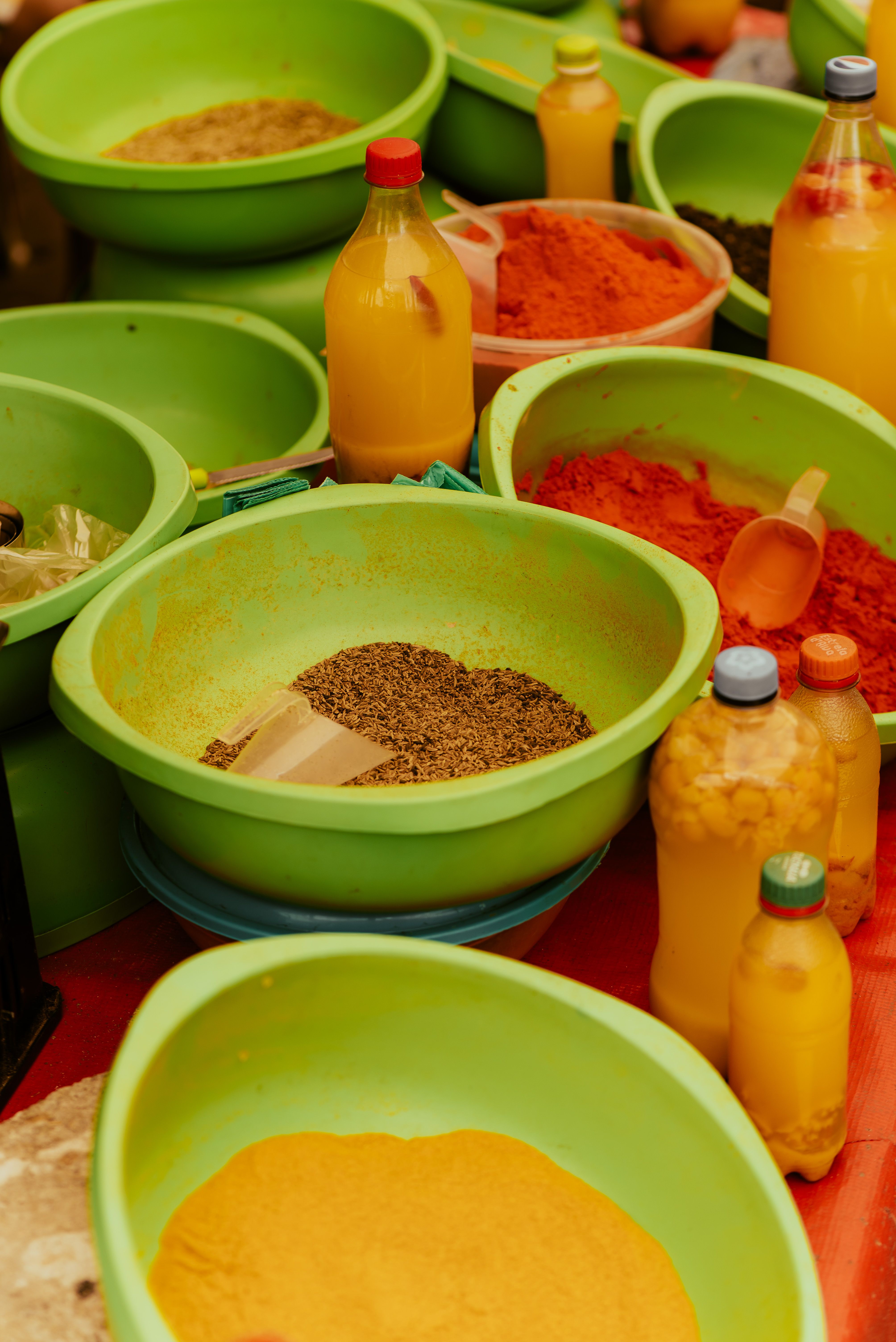 A colorful array of spices and oils in a market setting showcasing diverse culinary ingredients.
