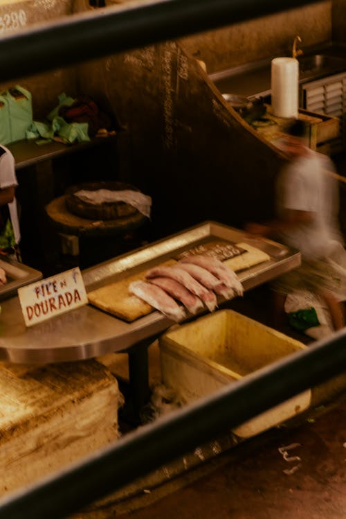 A man is standing in front of a fish counter