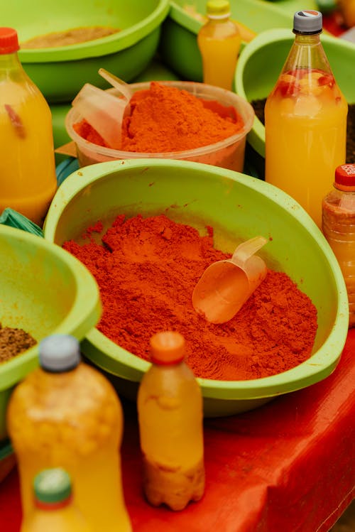 A table with bowls of spices and other items