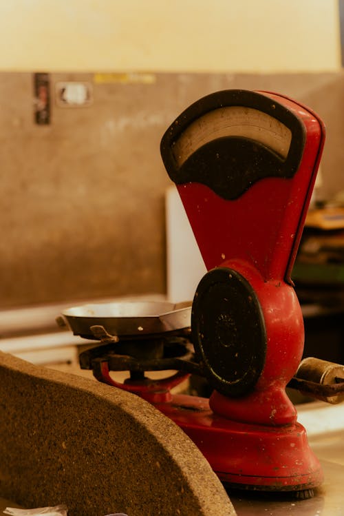 A red scale on a counter with a red and black clock