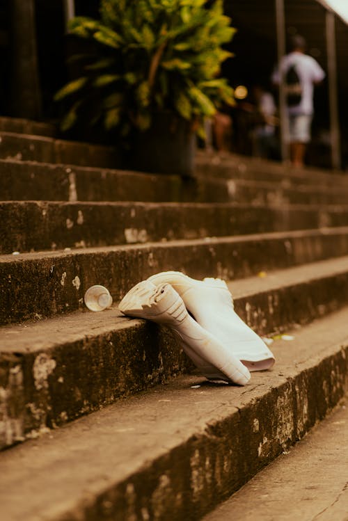 A white shoe on the steps of a building