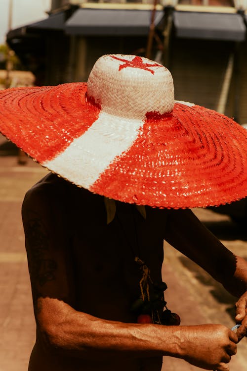 A man wearing a red and white hat