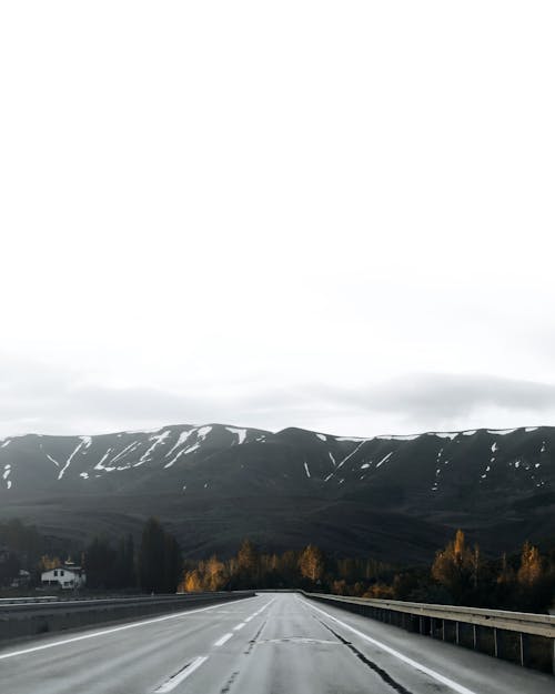 A highway with mountains in the background