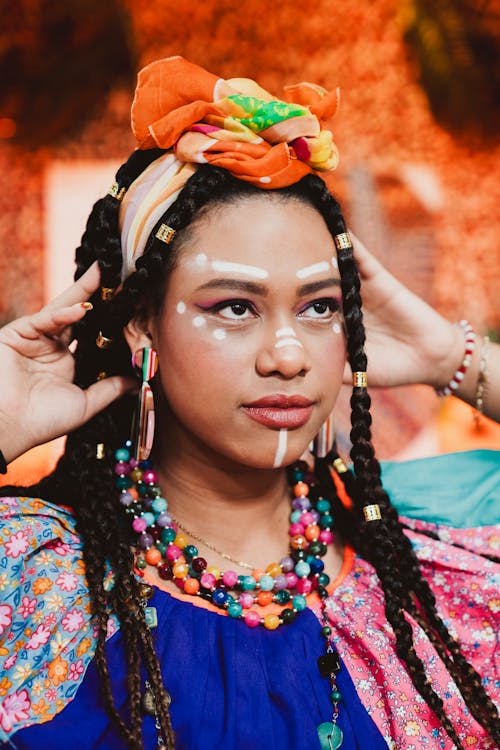 A woman with colorful hair and colorful jewelry