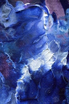 Creative abstract painting with blue and white textures on a vertical canvas.