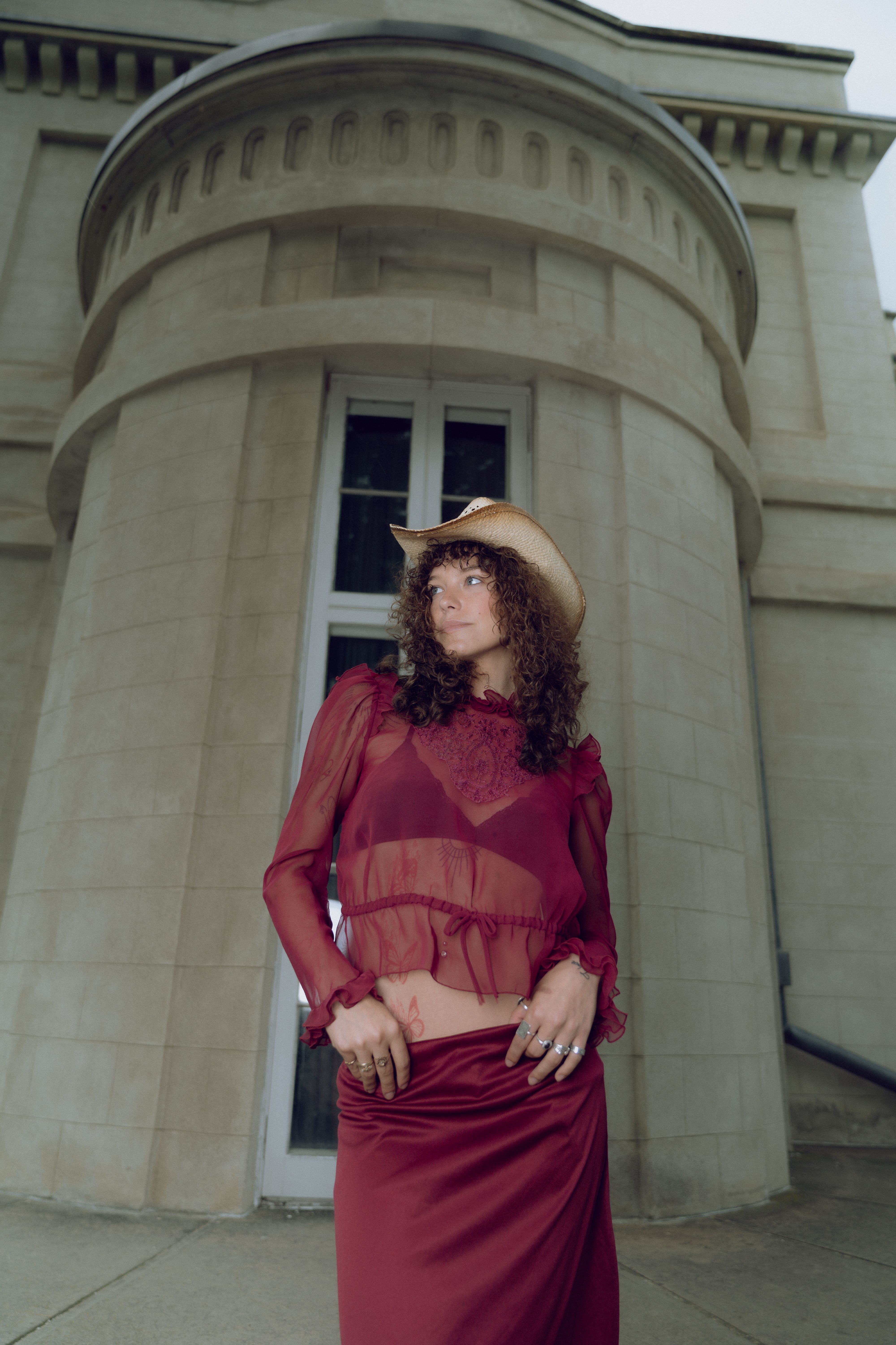 A woman in a red dress and hat posing for a photo · Free Stock Photo