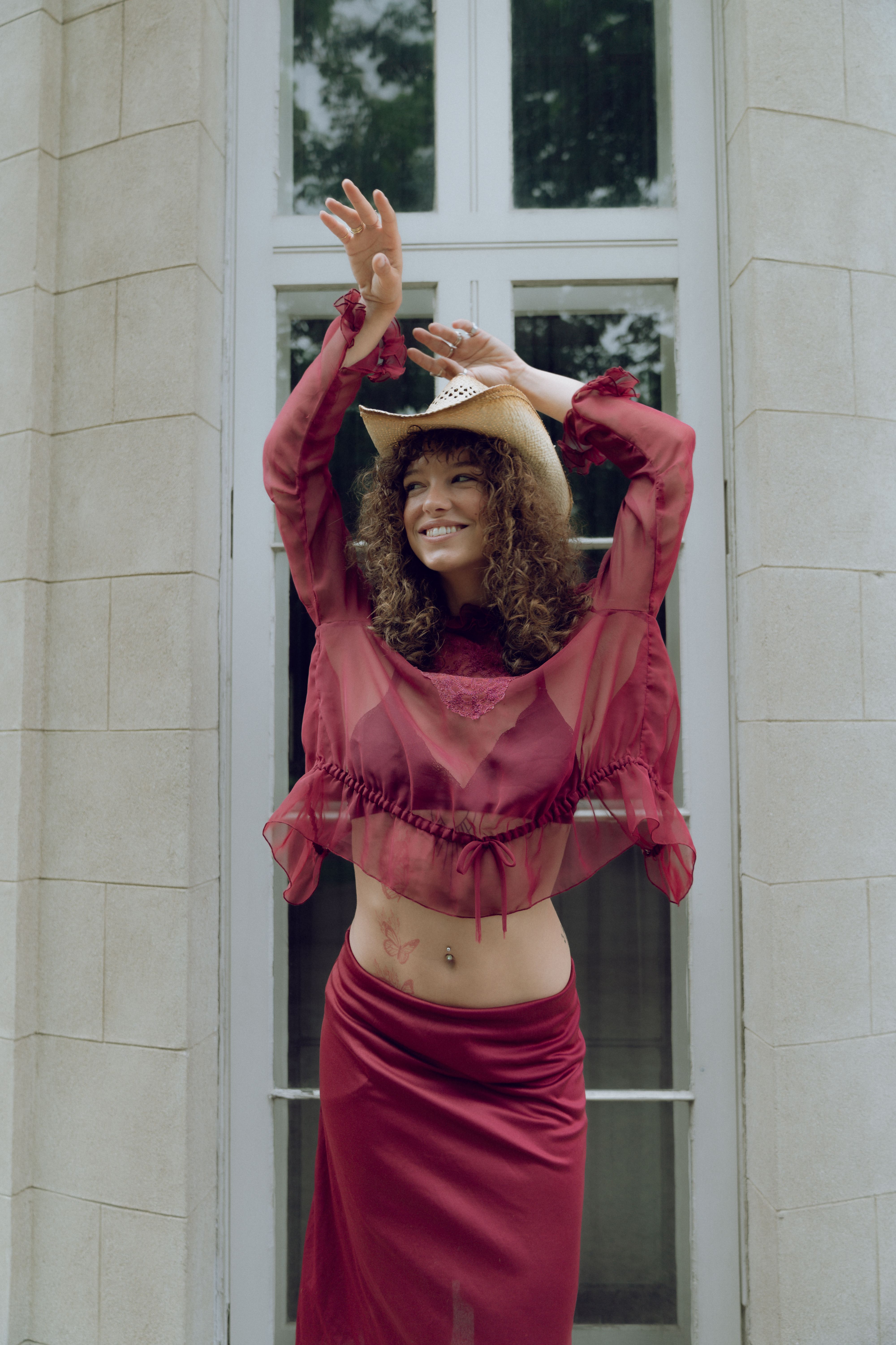 A woman in a red dress is posing for the camera · Free Stock Photo