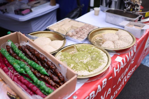 A variety of Middle Eastern desserts displayed at a street food market, featuring vibrant colors and textures.