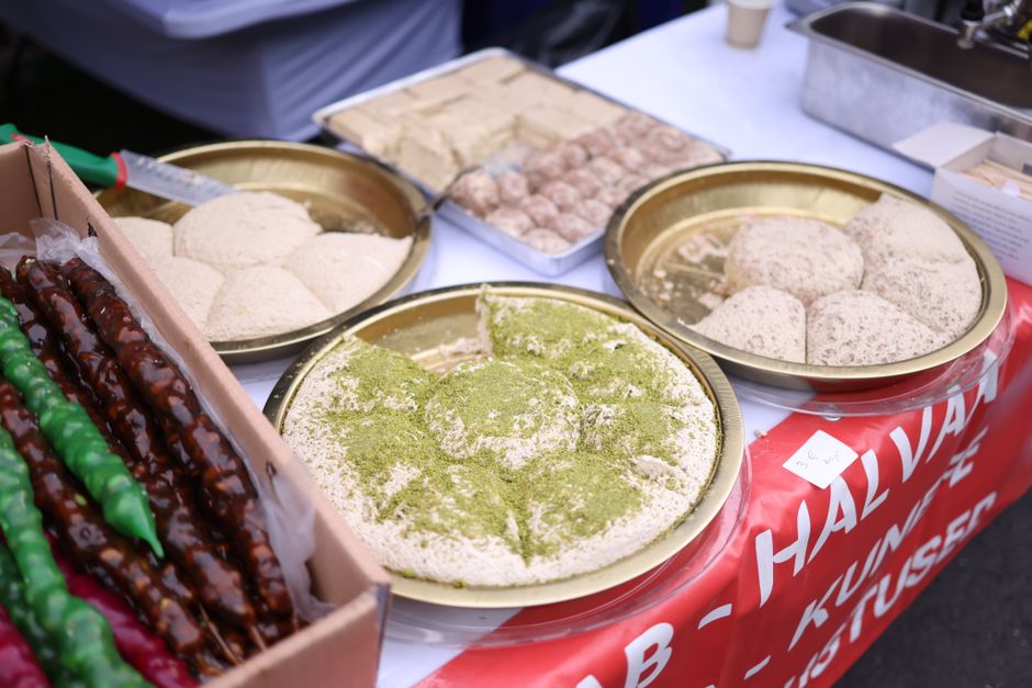 A collection of Turkish sweets and snacks displayed at an outdoor market, showcasing a variety of flavors.