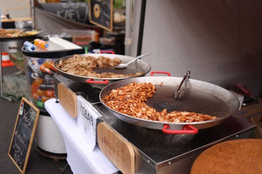 Close-up shot of a street food stall with kebab preparation in large pans, offering a vibrant dining experience.