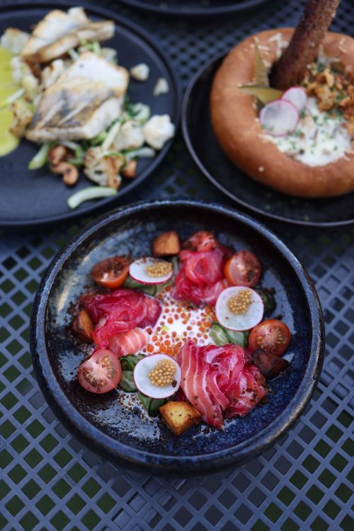 Free Elegant presentation of seafood with salmon, radishes, and caviar in a rustic setting. Stock Photo