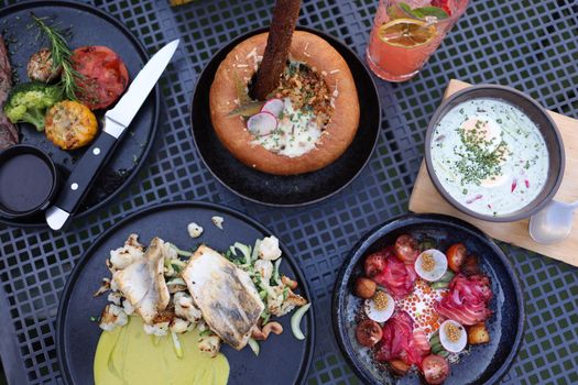 Top view of a variety of gourmet dishes on a table, showcasing fine dining presentation.