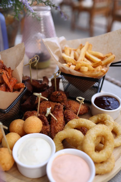 A platter of food with fries, onion rings and dip