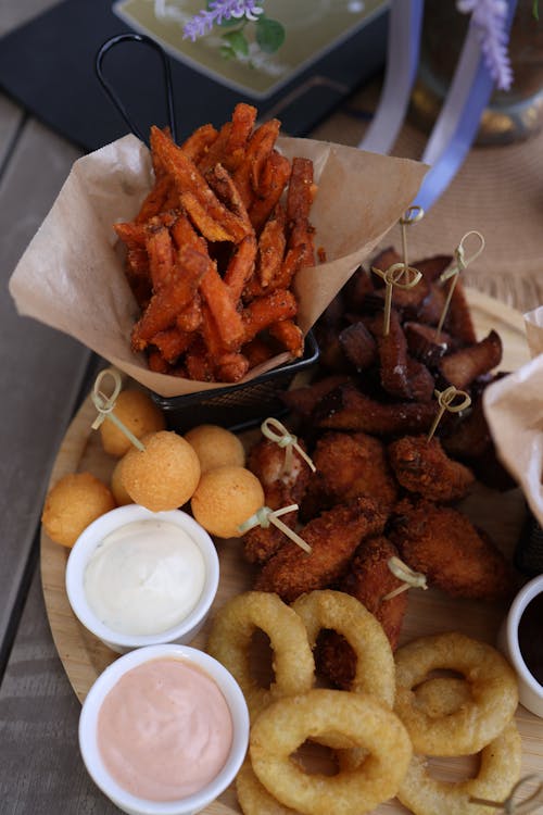 A platter with fried food and dipping sauces