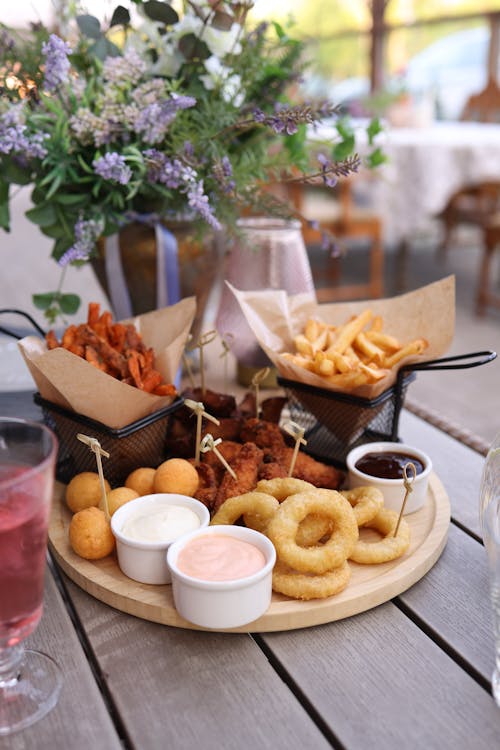 A wooden table with a plate of food and drinks