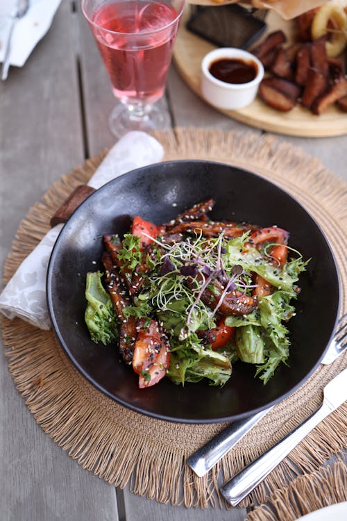 A salad with chicken and vegetables on a plate