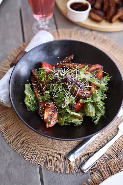 A salad with chicken and vegetables on a plate