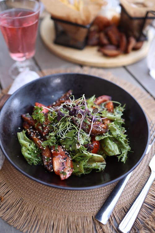 A salad with chicken and vegetables on a plate