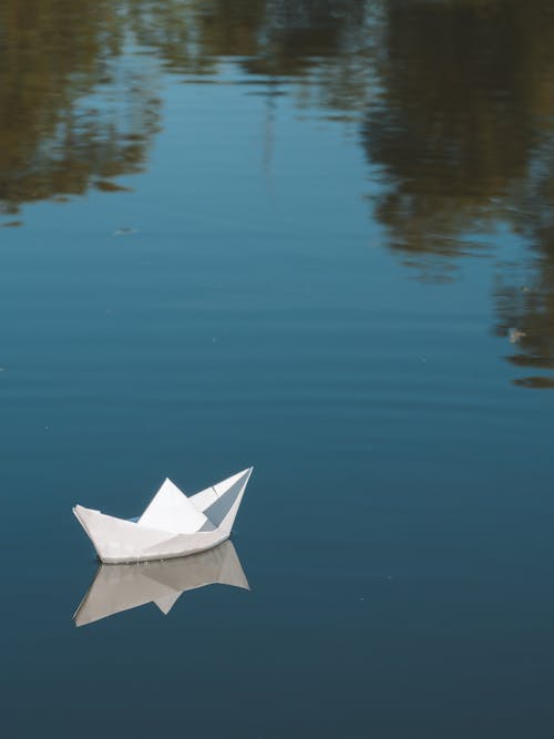 Paper boat floating on water