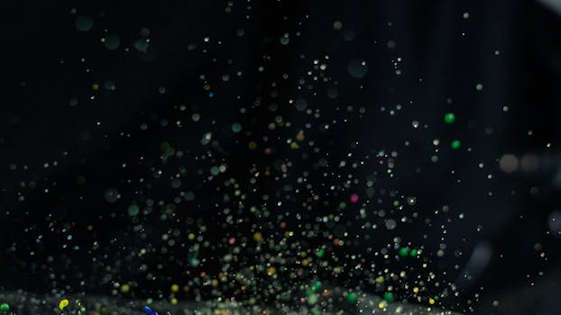 Vibrant multicolor paint splatter captured in motion with a dark backdrop, ideal for creative design.