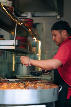 Chef at work in a Ciudad de México restaurant, focused on preparing a traditional dish.