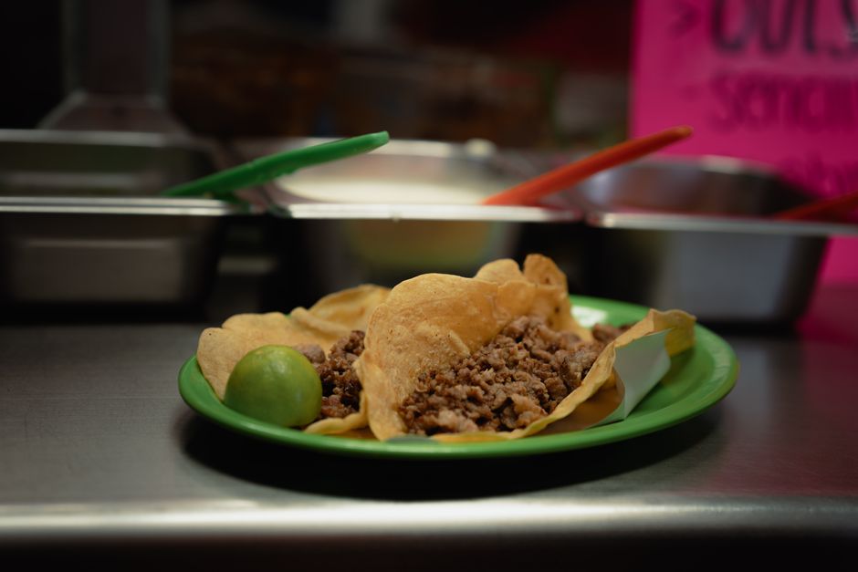 Close-up of delicious tacos al pastor with pineapple, cilantro, and onion.