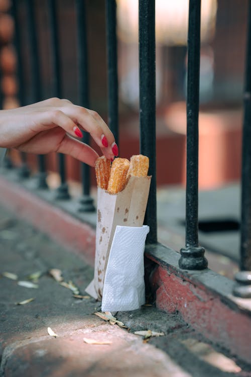 A person holding a bag of french fries