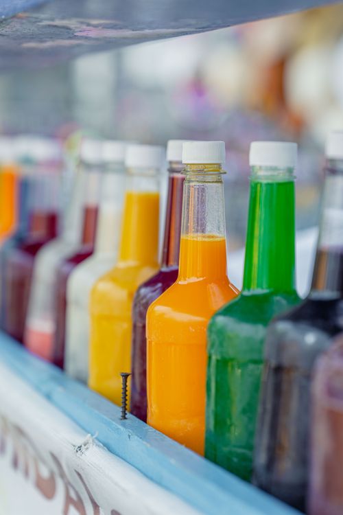 Free Vibrant selection of multi-colored bottled drinks in Mexico City. Perfect for beverage-related designs. Stock Photo