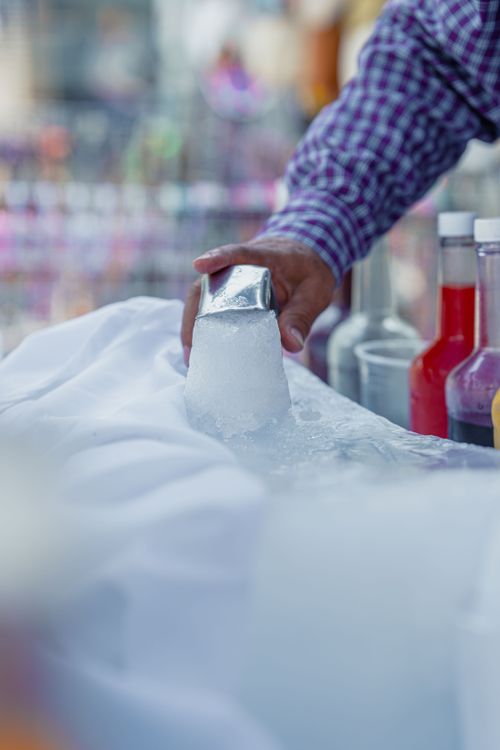 Free A vendor prepares traditional Mexican shaved ice with syrup in Ciudad de México. Stock Photo