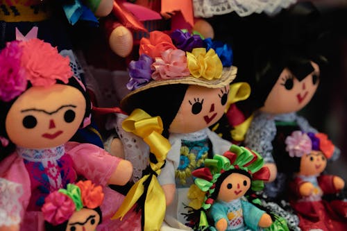 A group of dolls with colorful hair and flowers