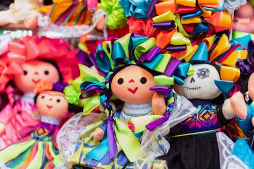 A group of colorful dolls with colorful ribbons