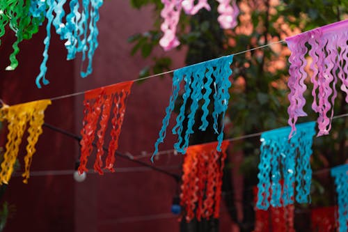 Colorful paper garlands hanging from a tree