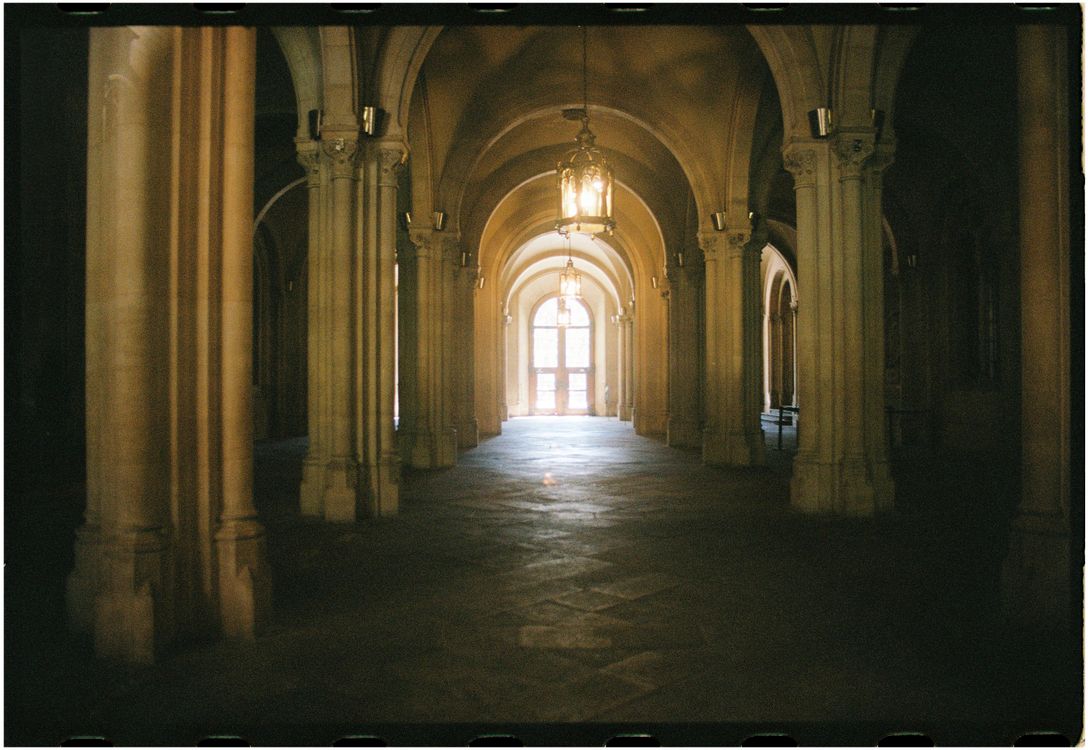 A long hallway with arches and columns · Free Stock Photo