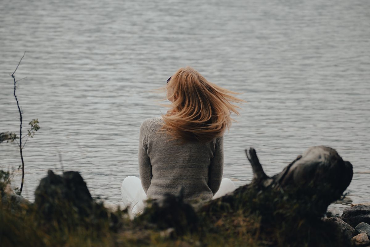 Woman Sitting on Concrete · Free Stock Photo