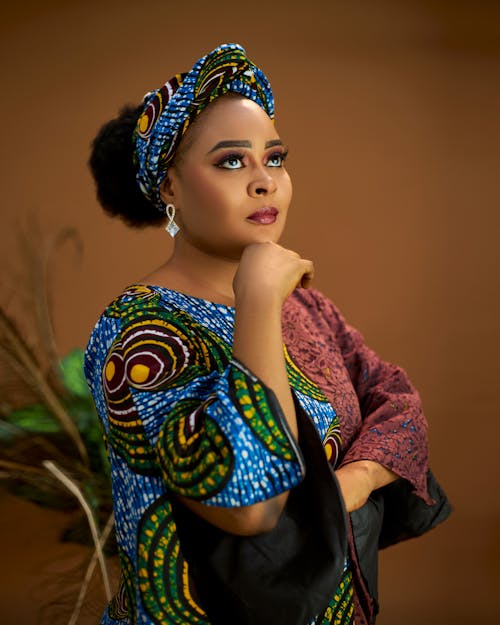 A woman in an african print dress and head wrap