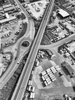 Black and white drone shot of an industrial area in Thurrock, England showing roads and buildings.