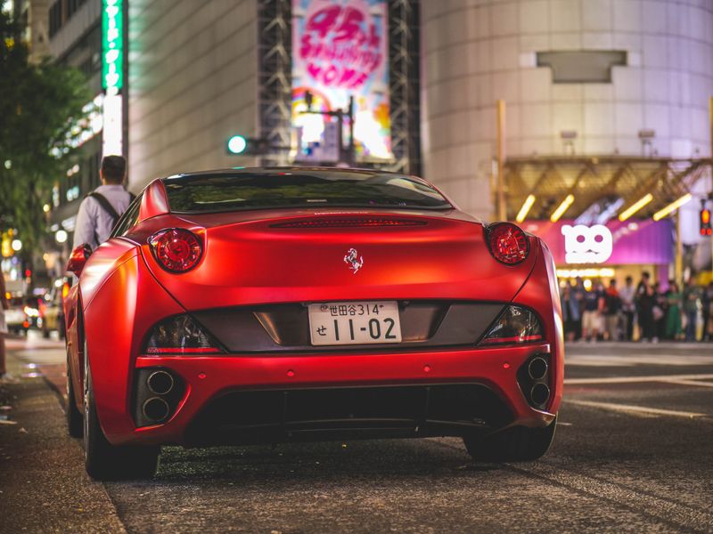 Ferrari driving city street at night