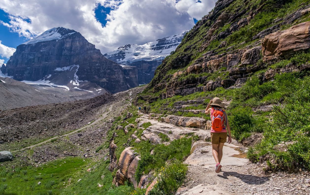 Person hiking on a mountain trail with a backpack